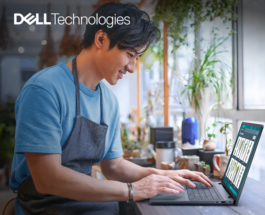 Laptop Dell 16 w kolorze srebrnym z widocznym logiem DELL i dynamicznym tłem